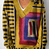 Žlutý svetr s abstraktním obrázkem a blokovým vzorem, výstřih do V